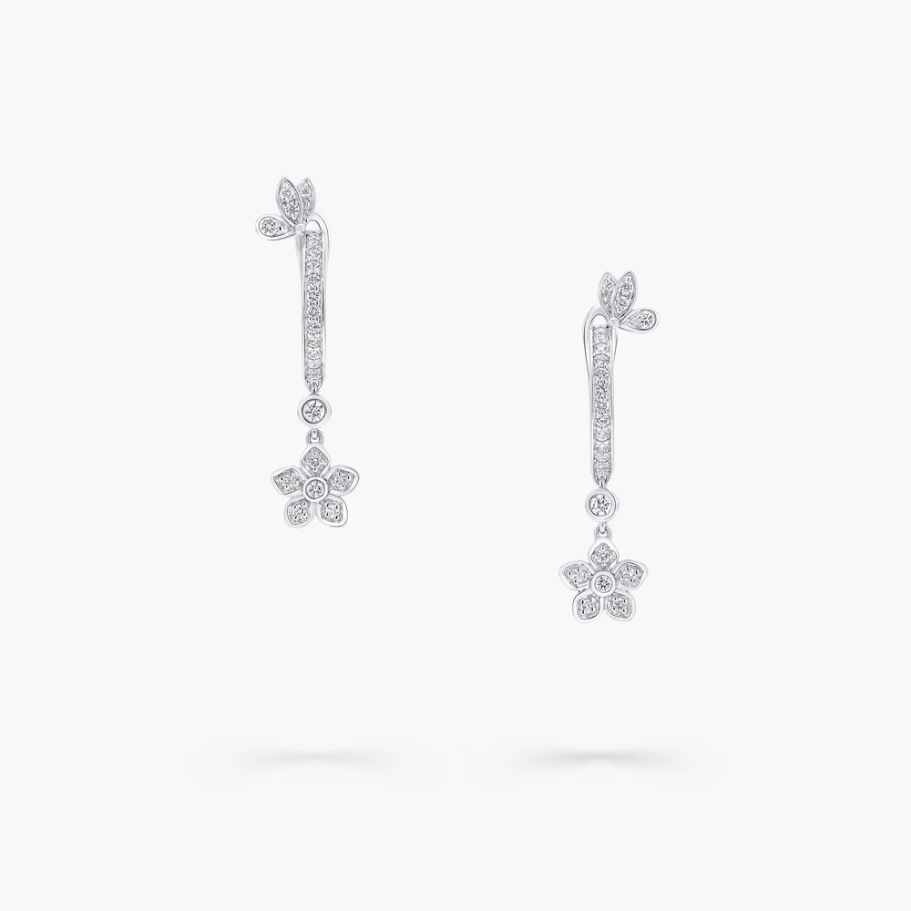 Graff sterling silver earrings with butterfly and flower designs and diamond hoop earrings