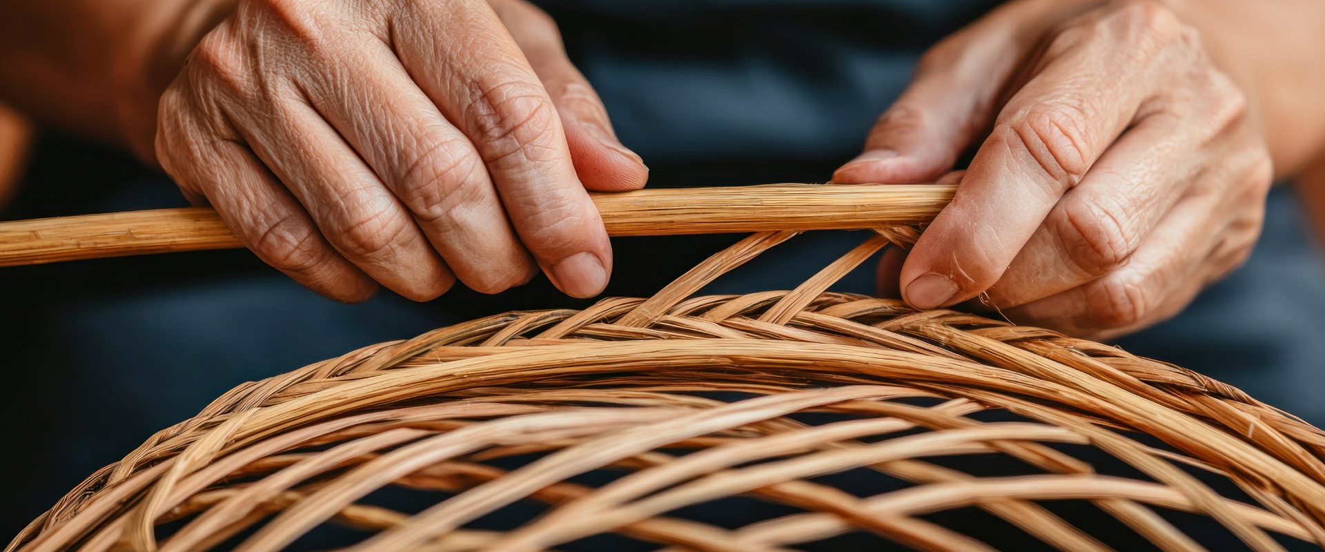 Craftsman hand weaving bamboo basket, showcasing traditional bamboo craftsmanship
