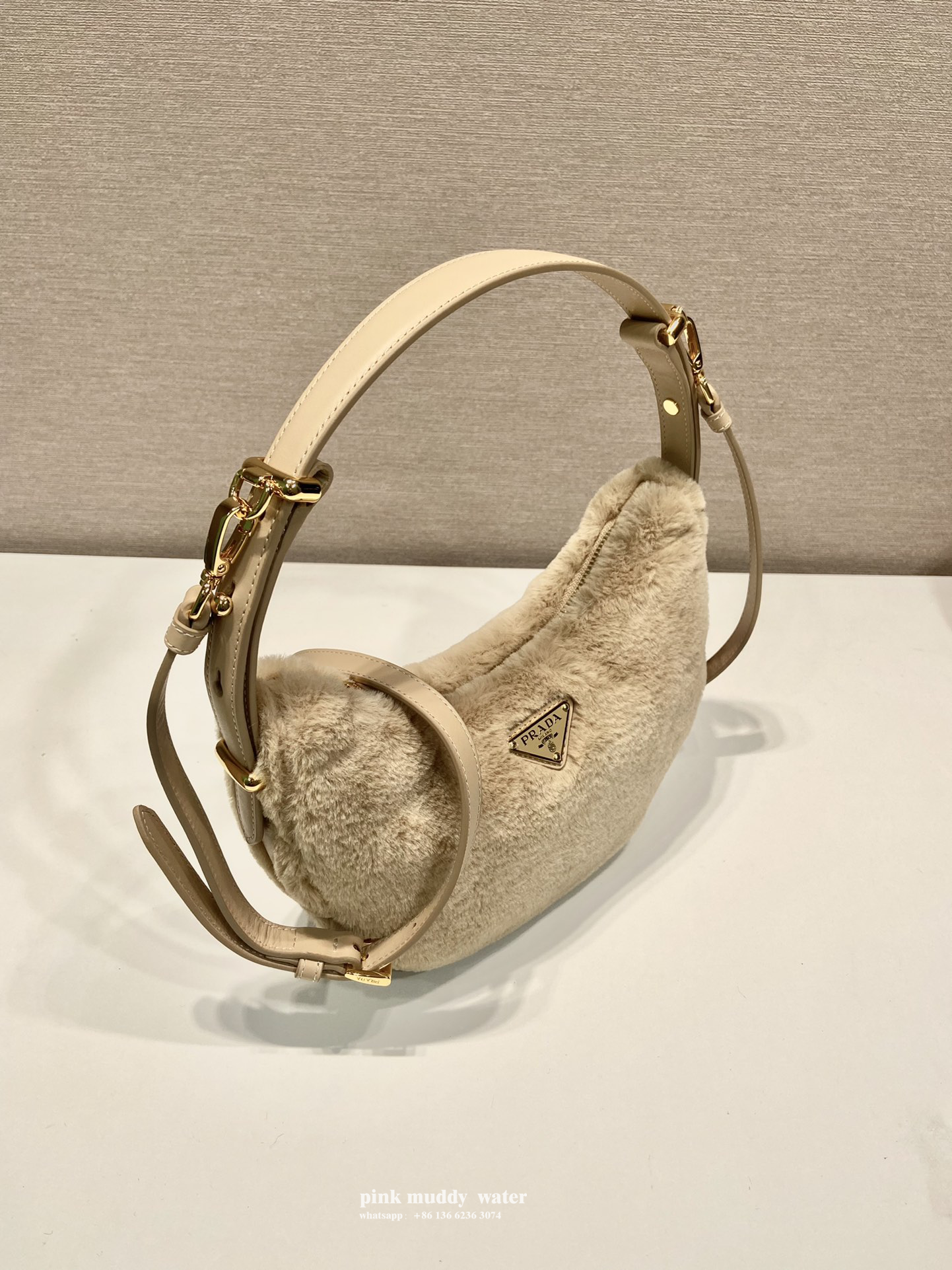 Prada Arqué shearling and leather shoulder bag