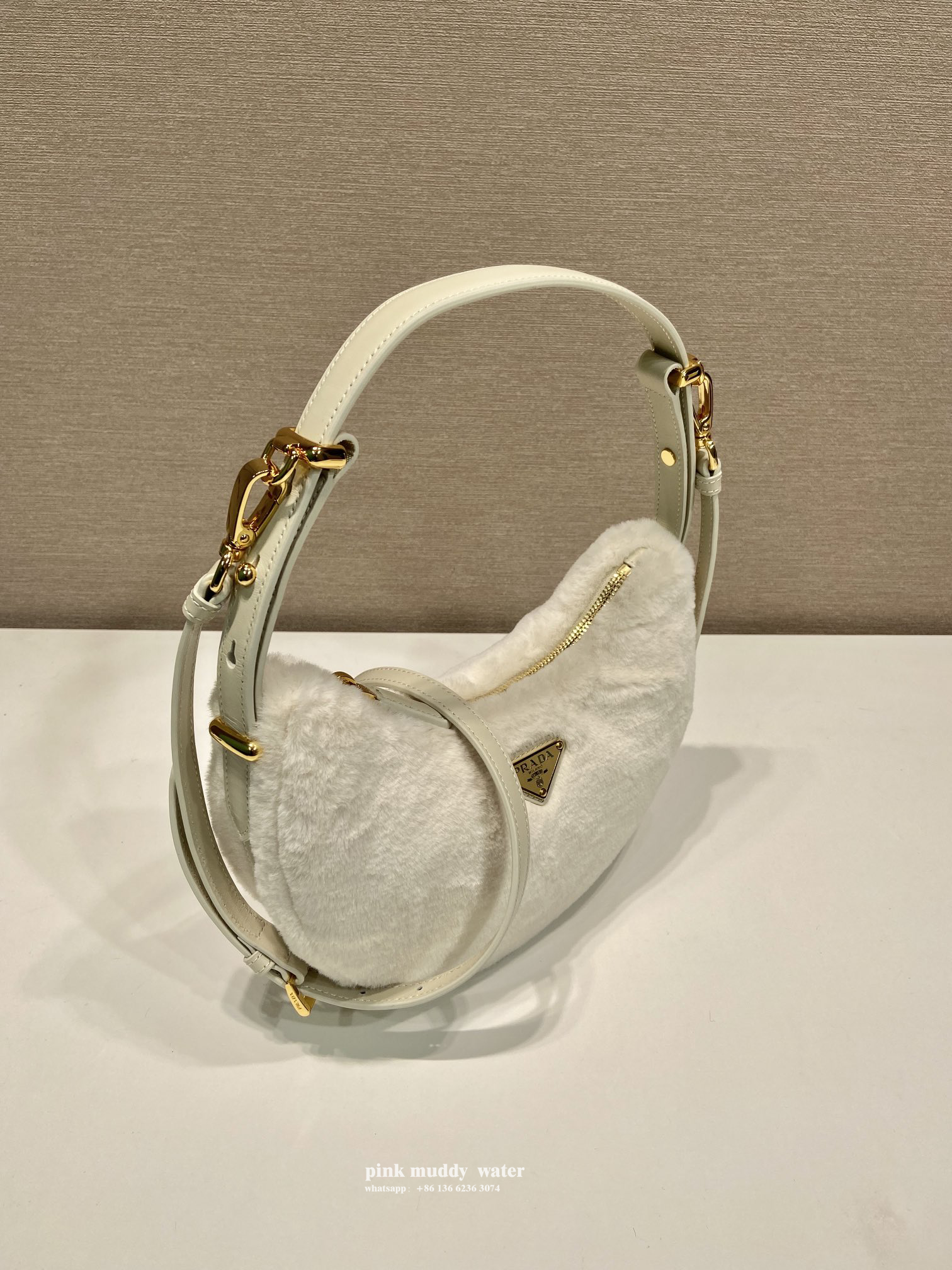 Prada Arqué shearling and leather shoulder bag