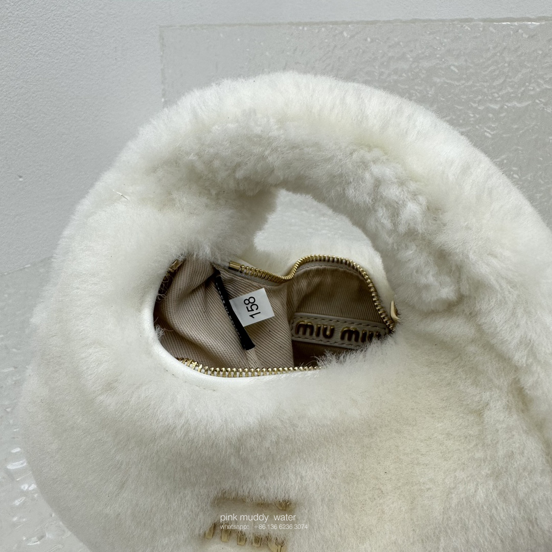 Wander leather detail shearling crescent bag