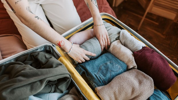 a person trying to adjust his Gulina online luxury brand item in a bag