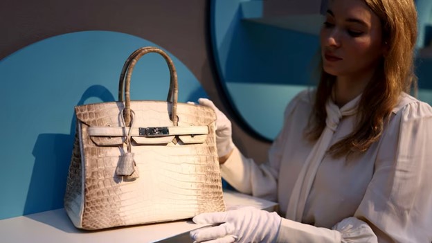 Woman touching hermes Diana bag